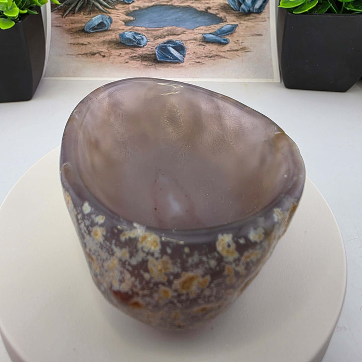 Hand carved Agate Bowl showcasing a smooth interior and rugged exterior, perfect for functional art display.