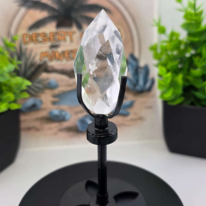 Polished Faceted Clear Quartz Crystal Tear Drop with Stand elegantly displayed on a custom metal stand.