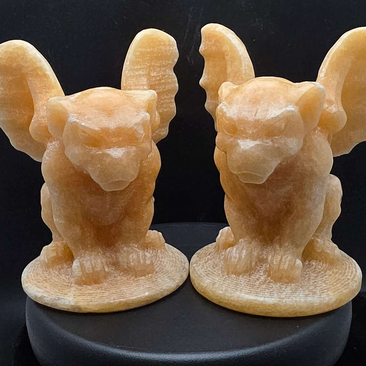 Yellow calcite gargoyle carving with wings relaxed, showcasing warm buttery yellow to honey-orange color.