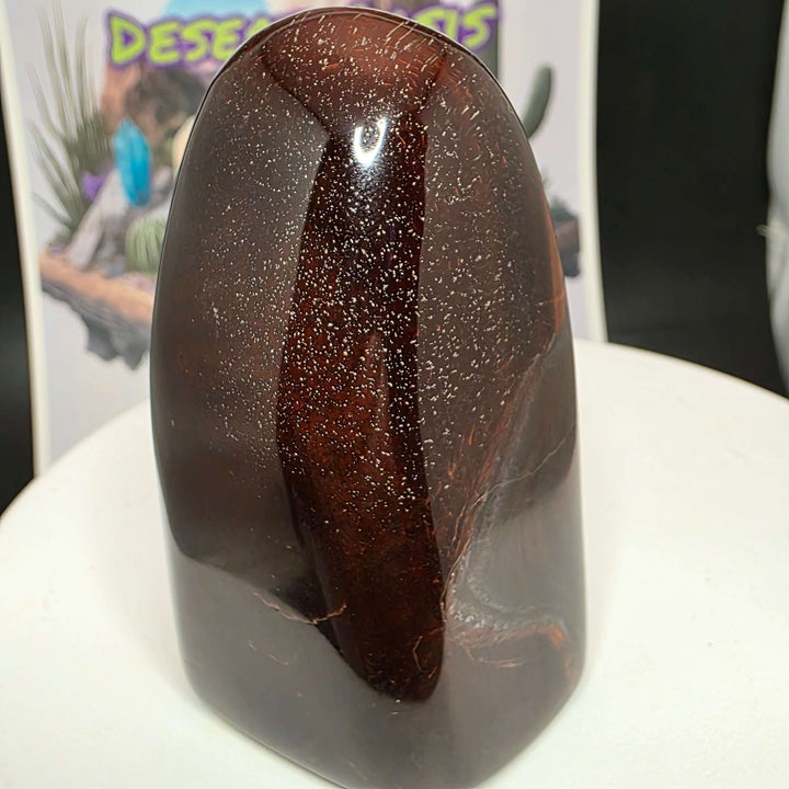 Polished Red Tiger's Eye freeform showcasing distinct reddish-brown colors and natural stone patterns.