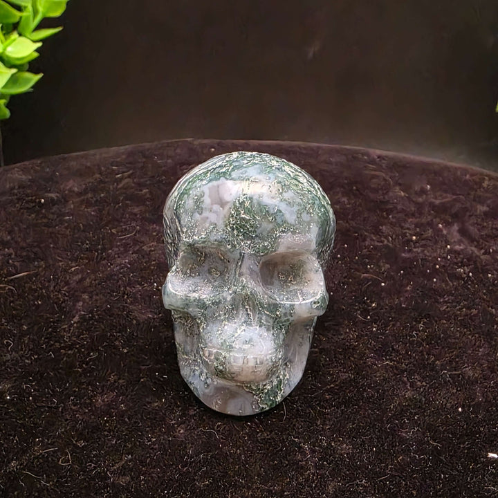 Moss Agate Skull Carving - 2 inch showcasing unique blue-green dendritic inclusions and frosty white matrix.