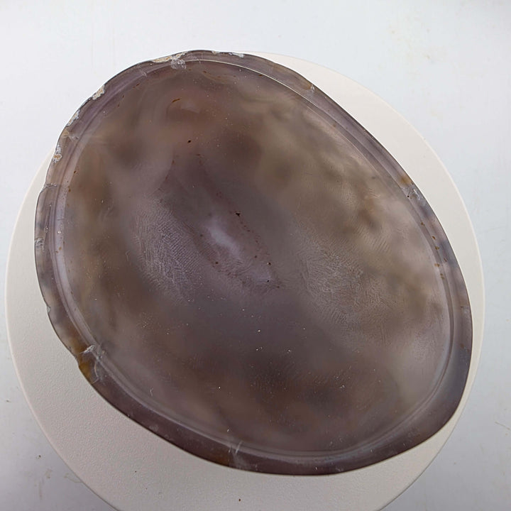Hand carved Agate Bowl showcasing a smooth interior and rugged exterior, perfect for functional art display.