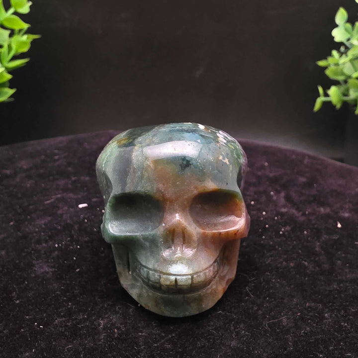  Orbicular Jasper Skull Carving - 2.25 Inch showcasing unique colors and textures on a dark background.