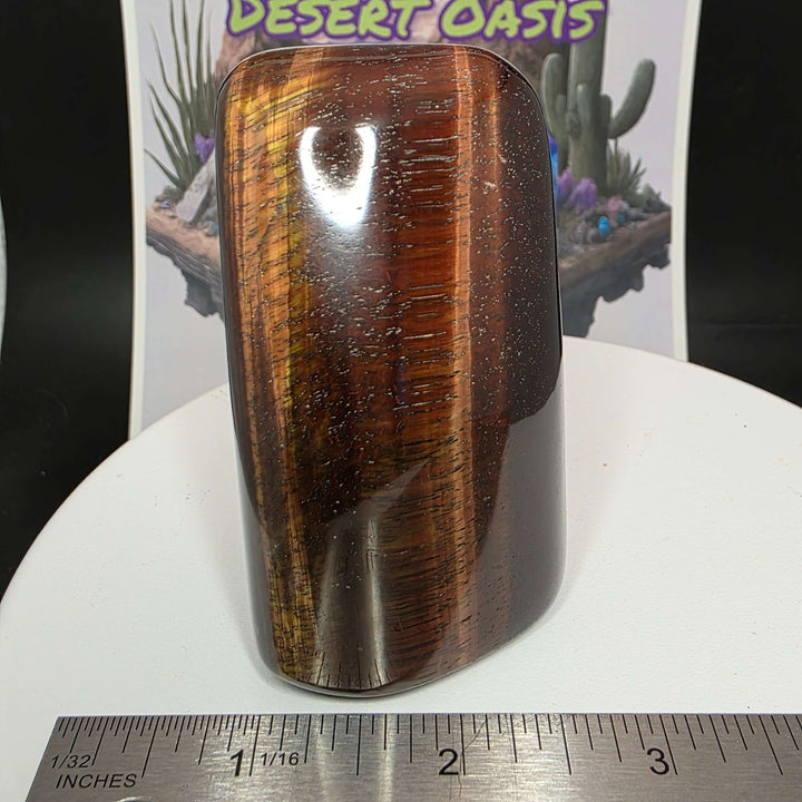 Polished Red Tiger's Eye freeform stone displaying reddish-brown hues and natural oxidation, perfect for decor or healing.