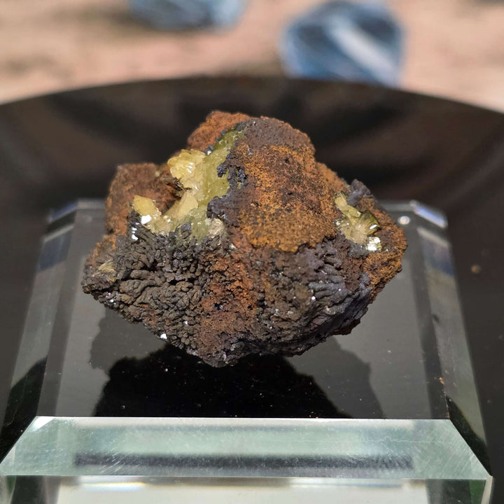 Adamite Specimen from Ojuéla Mine displayed on a clear pedestal, showcasing unique crystal formation.