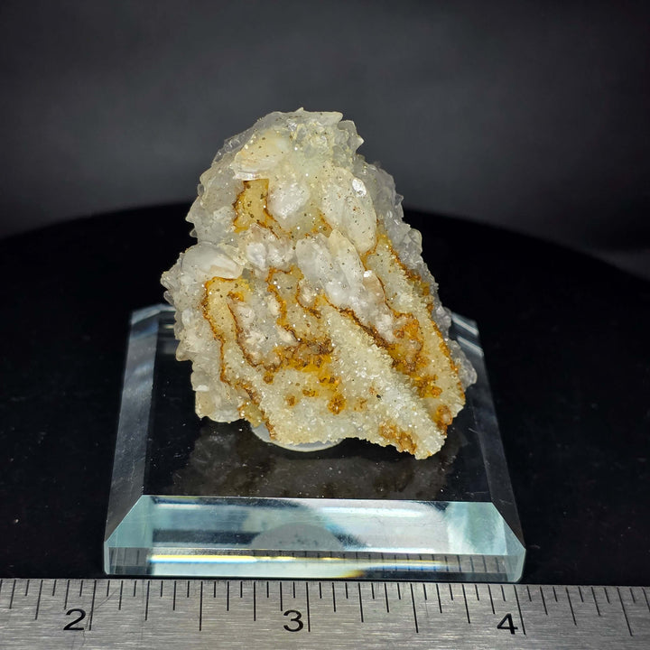 Calcite specimen with glass display stand from Guerrero, Mexico showcasing unique mineral growth patterns.