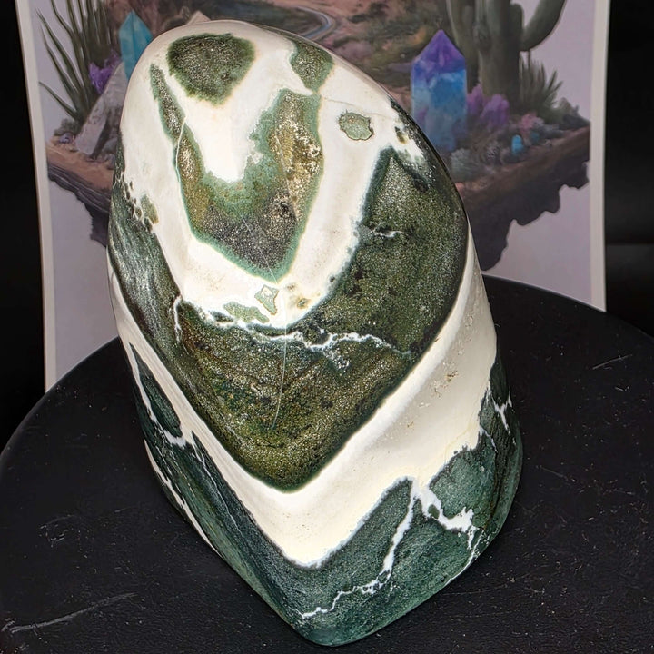 Polished Green Zebra Jasper freeform stone showcasing green, gray, and white stripes, smooth surface and unique patterns.