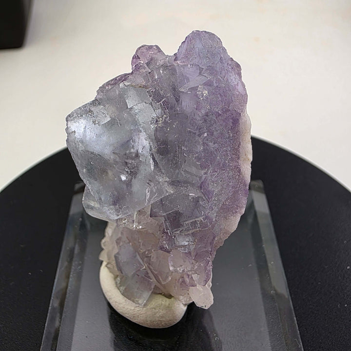 Fluorite Specimen - Yaogangxian Mine China featuring intergrown violet crystals on a display base.