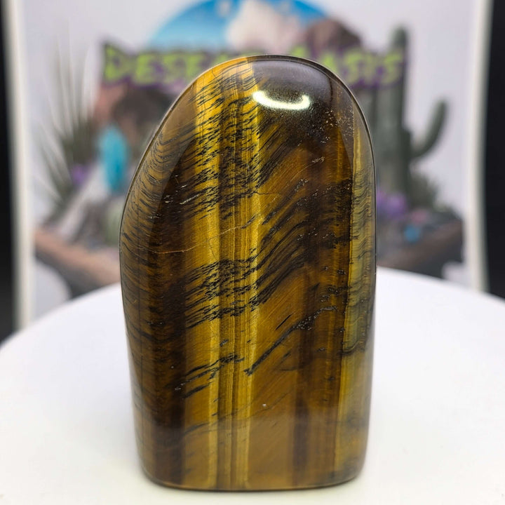 Polished Tiger's Eye freeform with golden chatoyancy and smooth texture on display.