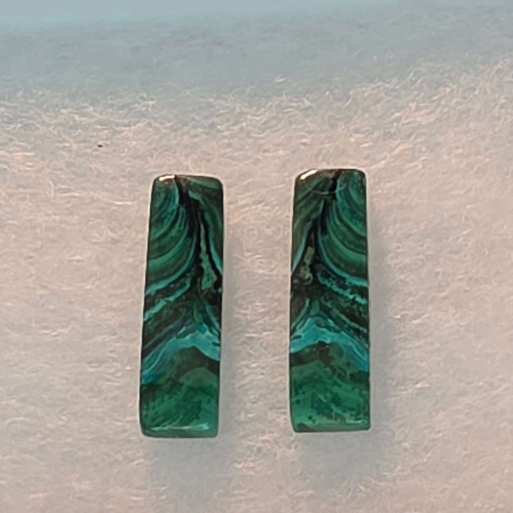 Bring the vibrant energy of nature into your home, or your next creative project, with our stunning Malachite Cabochon Pairs. Each pair features beautifully polished malachite, showcasing its unique swirling patterns, elegantly presented in a crisp white