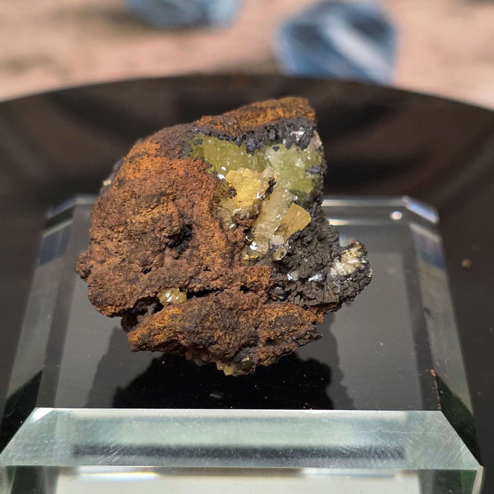 Adamite Specimen from Ojuéla Mine showcased on a display, featuring distinctive crystal formations and vibrant colors.