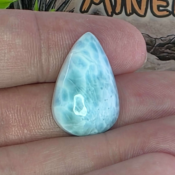 Dive into the tranquil beauty of our Larimar Cabochons. Sourced from the Dominican Republic, these rare and captivating gemstones showcase stunning shades of oceanic blues and whites, reminiscent of Caribbean waters. Each beautifully polished cabochon pai