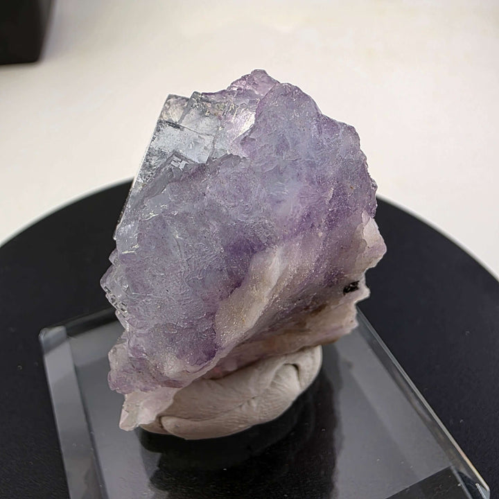 Fluorite Specimen - Yaogangxian Mine China featuring intergrown violet crystals on a display base.