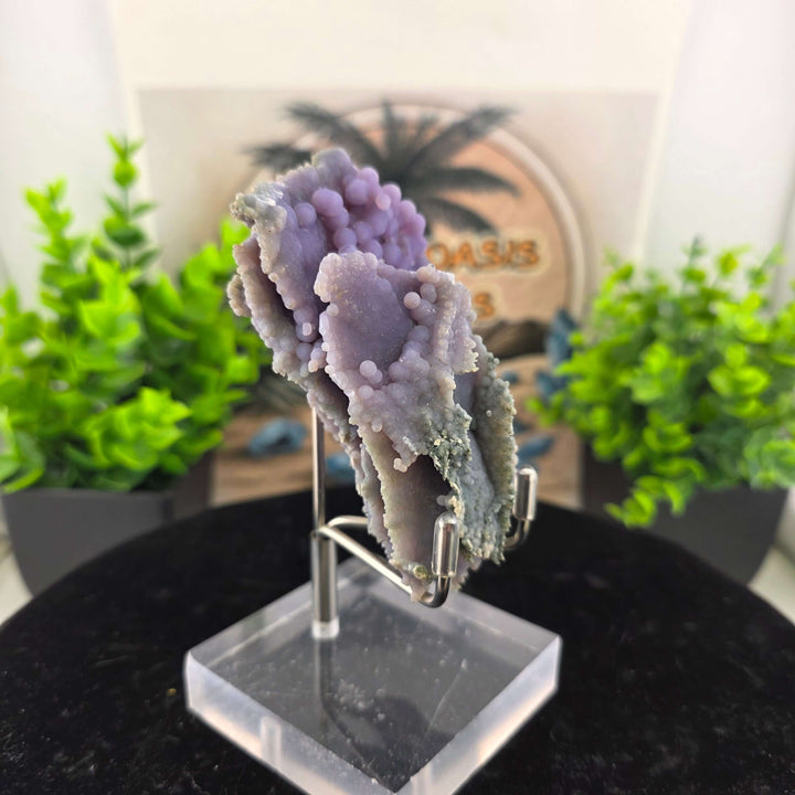 Discover the unique beauty of ‘Grape Agate’, an Amethystine Spherical Quartz found in Indonesia. This gemstone is known for its grape-like clusters and vibrant colors. Stand is included with purchase