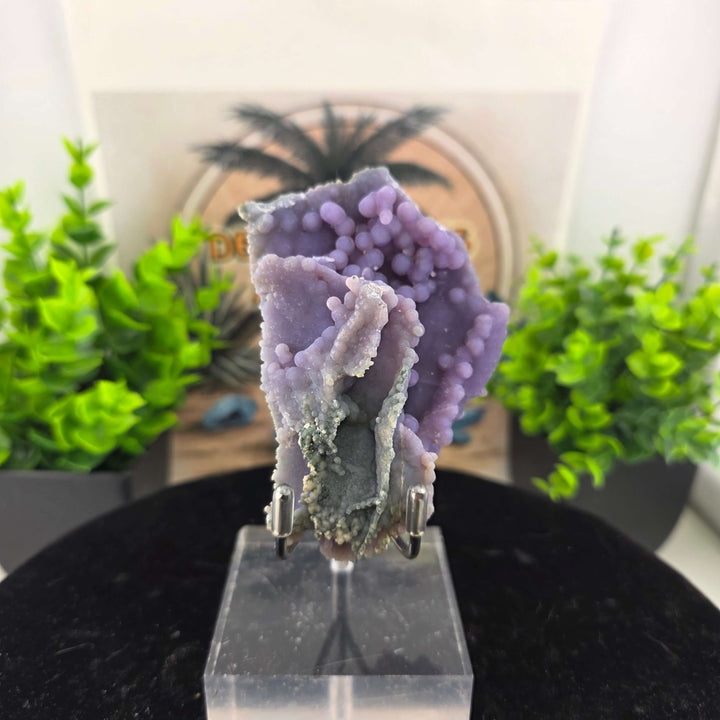 Discover the unique beauty of ‘Grape Agate’, an Amethystine Spherical Quartz found in Indonesia. This gemstone is known for its grape-like clusters and vibrant colors. Stand is included with purchase