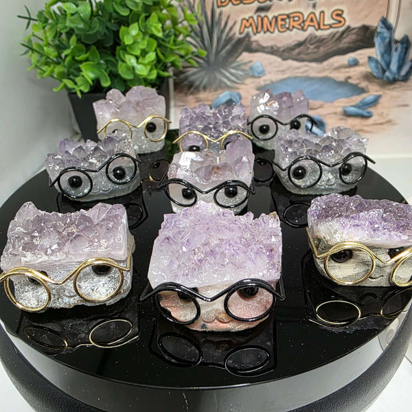 Various Crystal Buddies - Specimen Carvings wearing glasses, showcasing unique natural crystal designs.