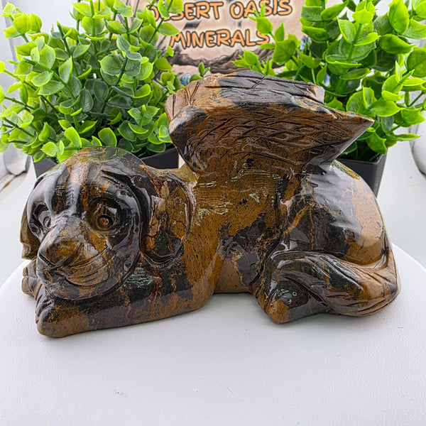 This delightful 5in x 3in x 3in wide carving features an Angel Dog, complete with charming wings. It is handcrafted from Mountain Jasper sourced from China, a type of picture jasper known for its captivating patterns that often evoke scenes of mountains,